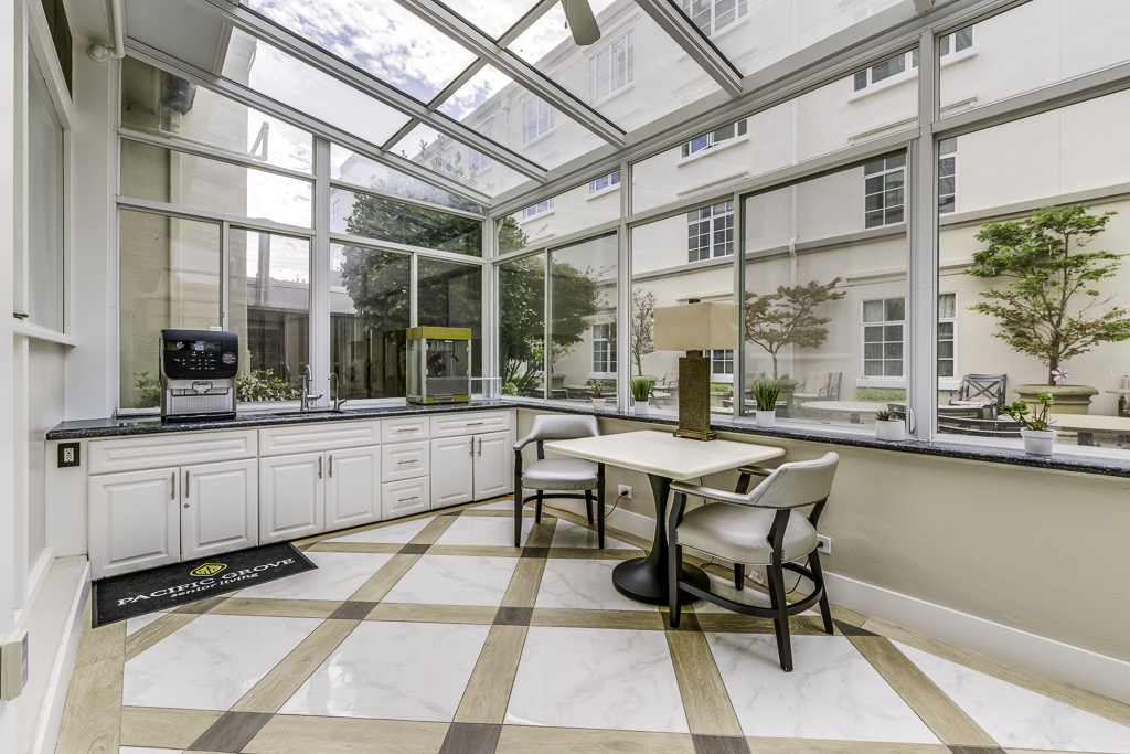 a table and two chairs in front of a window