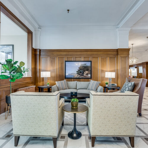 lounge area with table, sofas and chairs